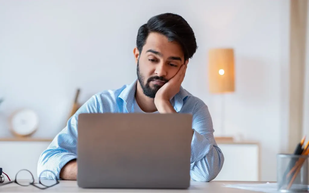 Business-owner-no-clients A bored business owner staring at their computer screen because they have no work or clients