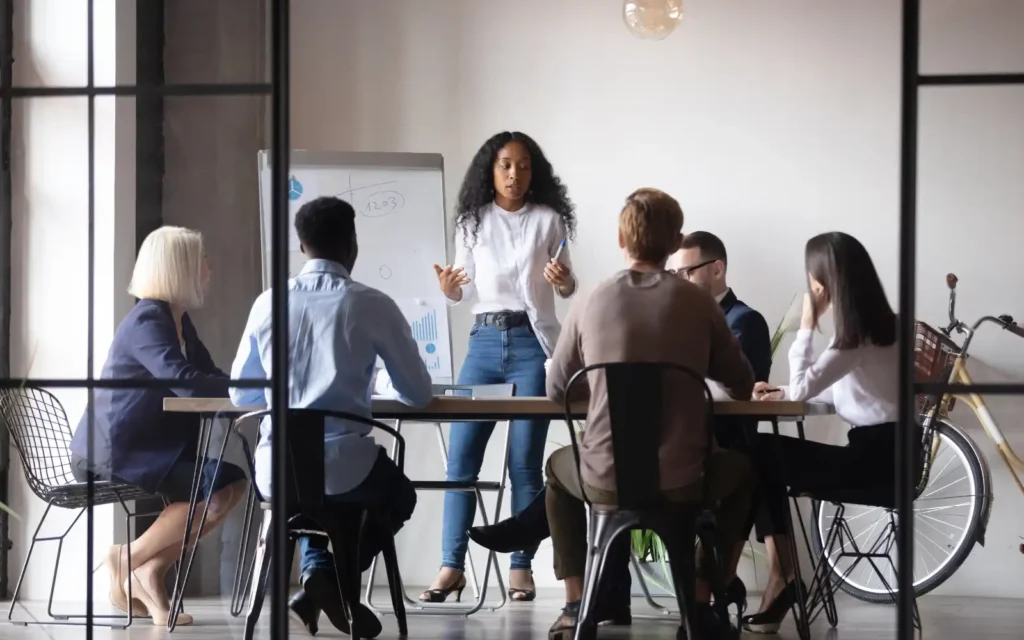Chosen A group of people sitting around a desk, representing getting chosen
