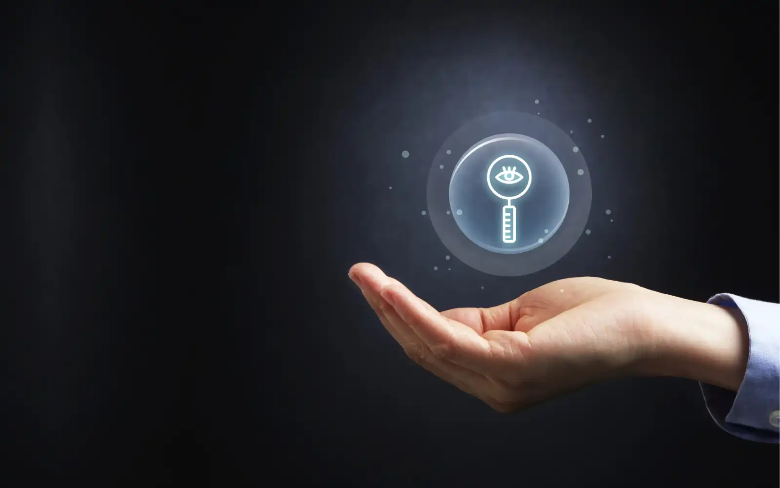 An outstretched hand with a magnifying glass floating in midair above it, representing getting chosen