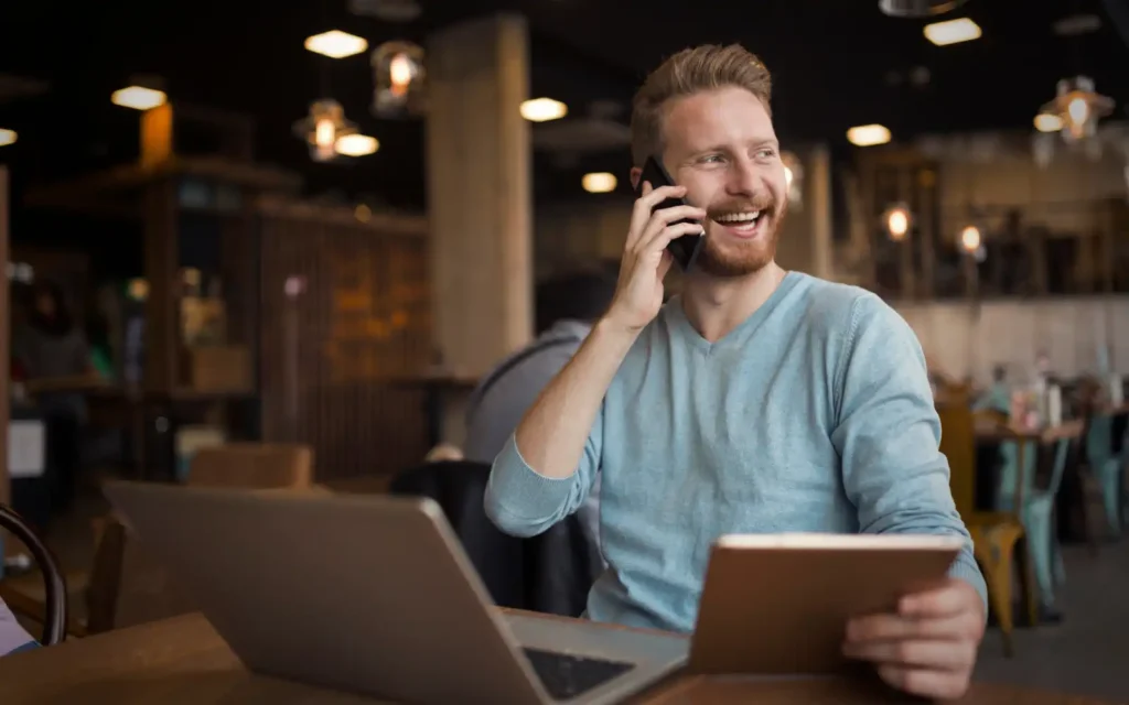 Shortlisted A smiling business man taking a phonecall from an inbound lead, representing getting shortlisted