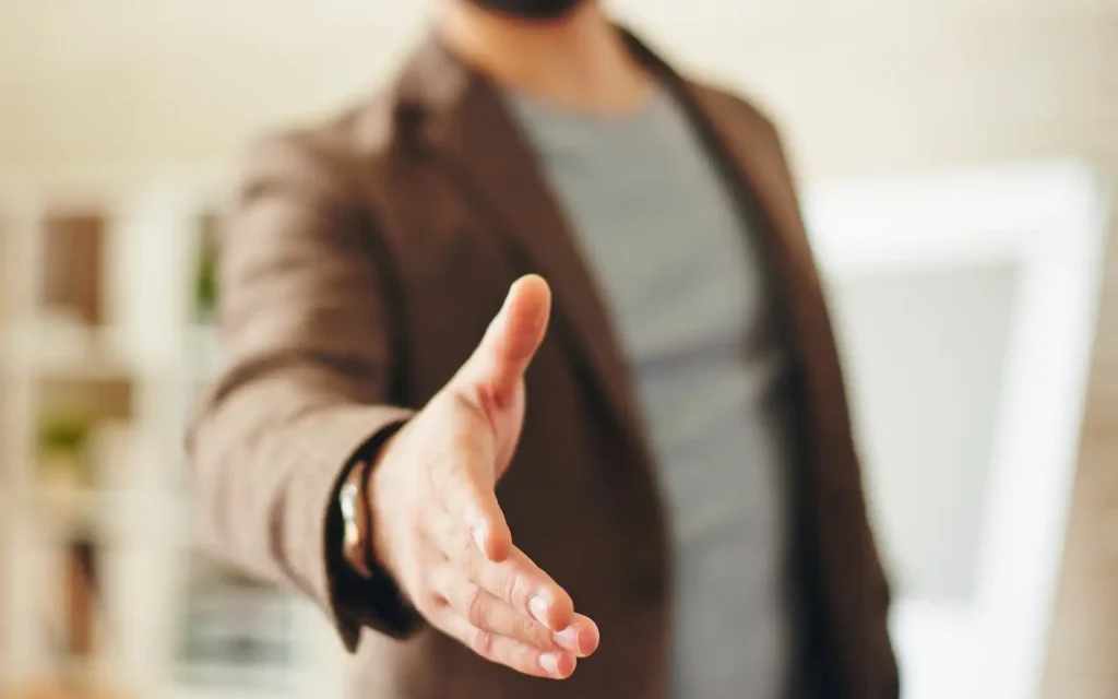 Signed-deal-handshake (2) A professional man extending his hand for a handshake, representing signed deals